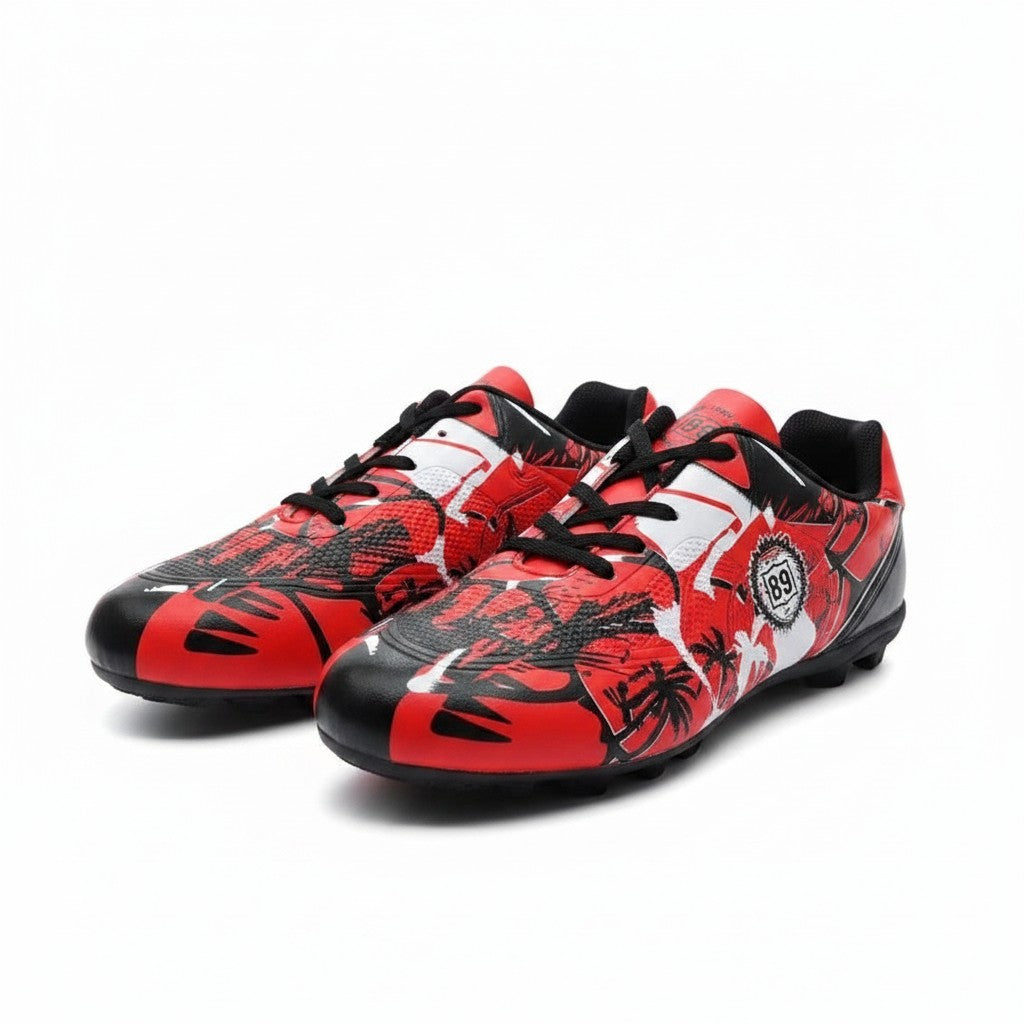 Swiftpick shop Pro-Performance low-top soccer cleats in red, white, and black with a graphic palm tree print pattern.